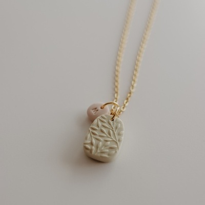 Colar dourado com pendentes bege e rosa com letras