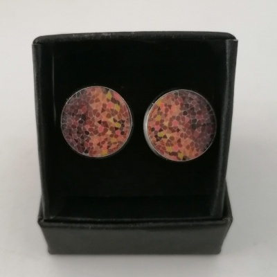 botões de punho redondos com padrão colorido em caixa preta