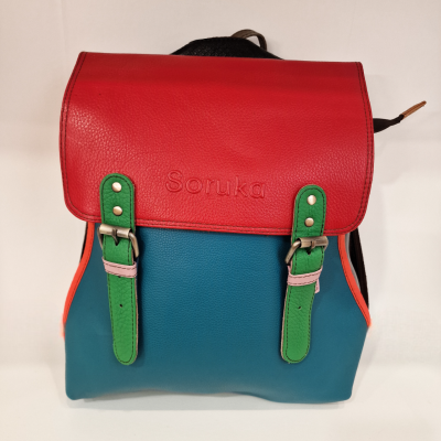 Mochila colorida com aba vermelha, corpo azul e fivelas verdes