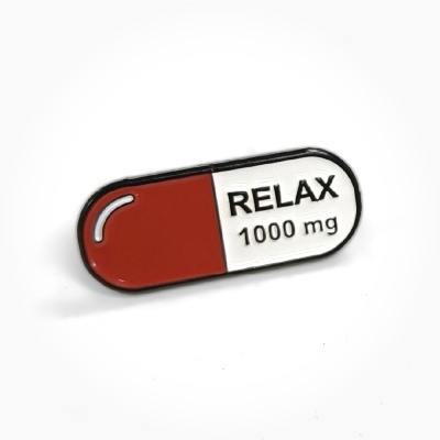 Capsule pin with RELAX 1000 mg text in red and white colors