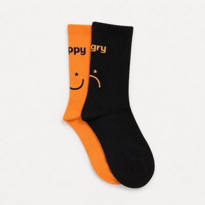 Orange and black socks with smiley faces and happy and angry text partially shown