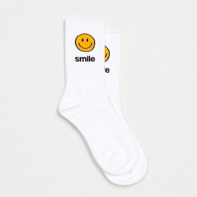 White crew socks with yellow smiley face and smile text