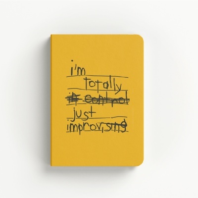 Yellow notebook with handwritten text on the cover