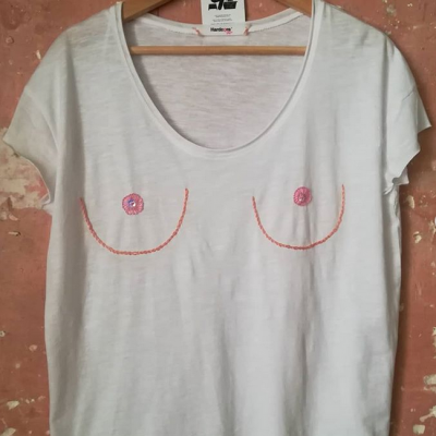 T-shirt branca com bordado de seios em linha cor-de-rosa e laranja