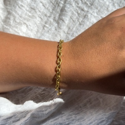 Pulseira dourada de elos em corrente no pulso