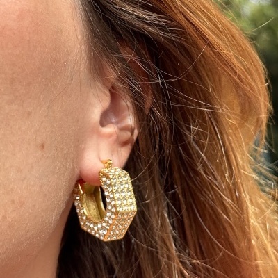 brinco dourado com cristais no lobo da orelha