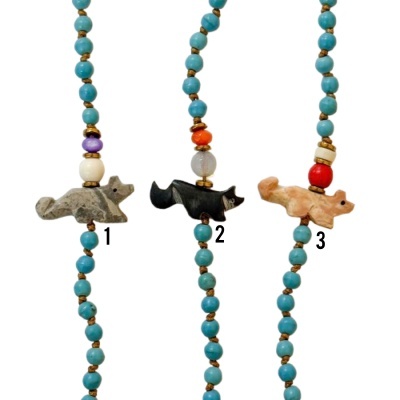 Colares com contas azuis e pingentes de raposas em pedra esculpida.