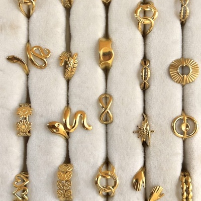 Anéis dourados variados em suporte de veludo branco