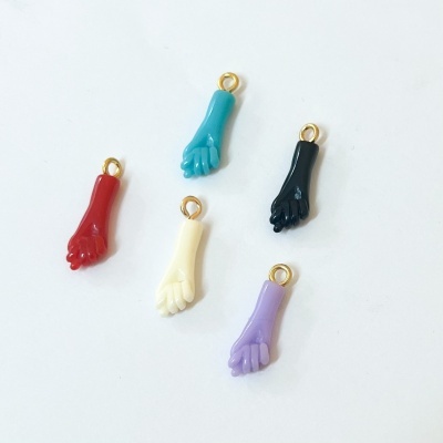 Cinco pendentes coloridos em forma de mão com argolas douradas em fundo branco