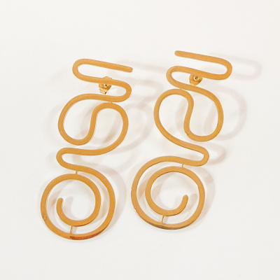 Brincos dourados em formato abstrato com linhas curvas