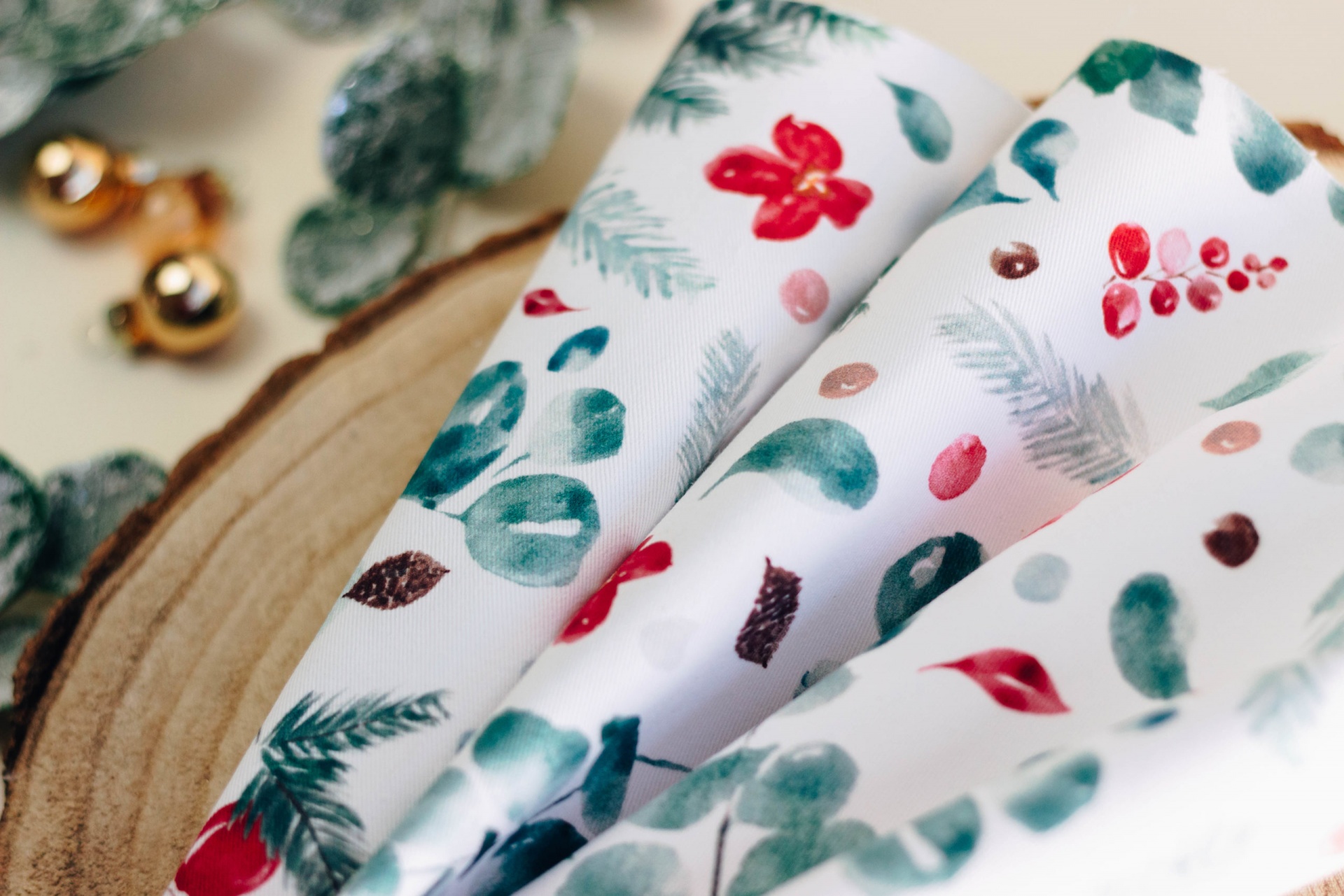 Papel de embrulho com padrão de folhas verdes e frutos vermelhos em fundo branco