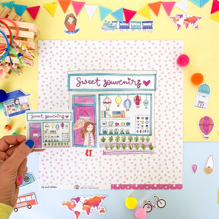 Papel decorativo com estampa de loja Sweet Souvenirs e elementos em papel colorido ao redor