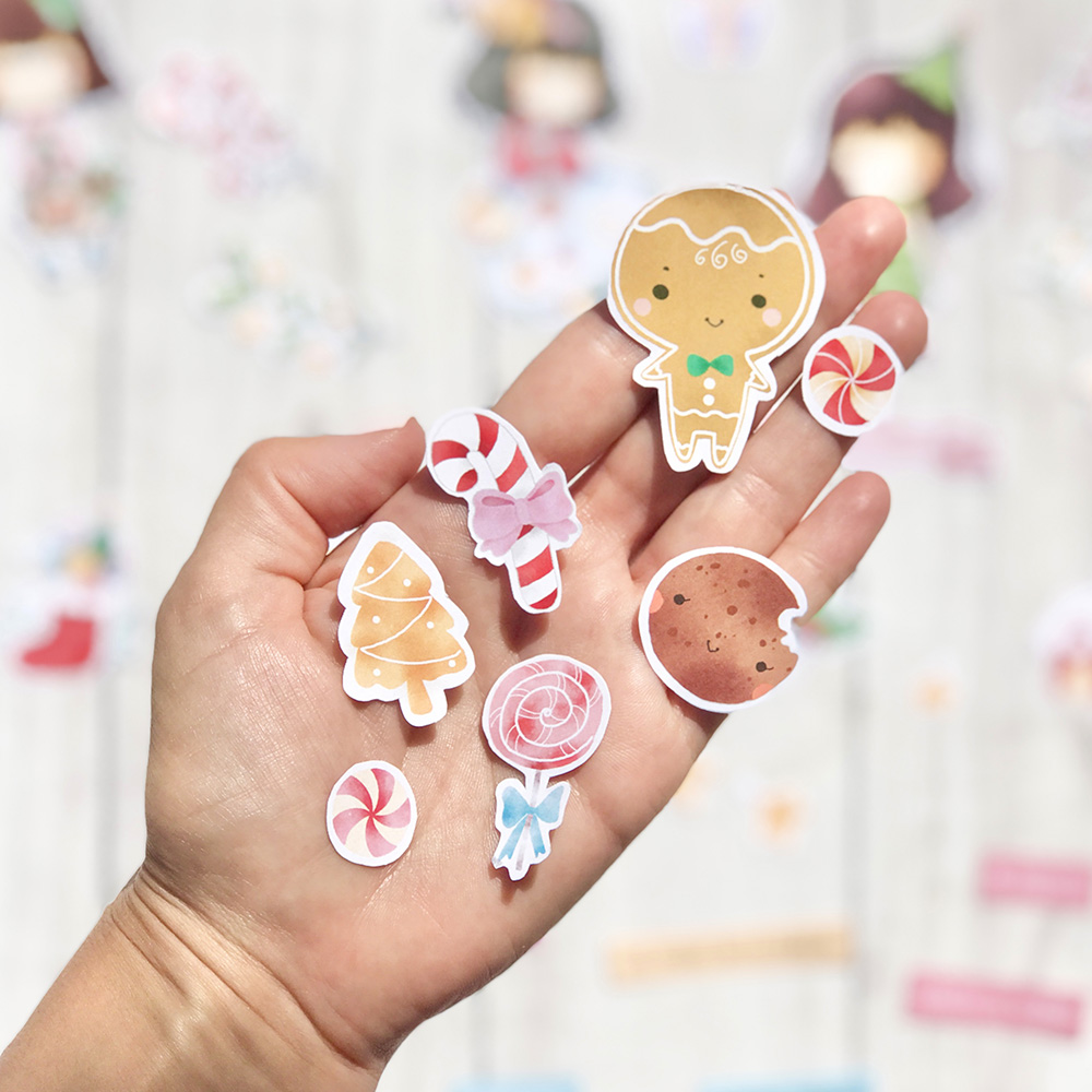 Autocolantes de Natal e doces na palma da mão