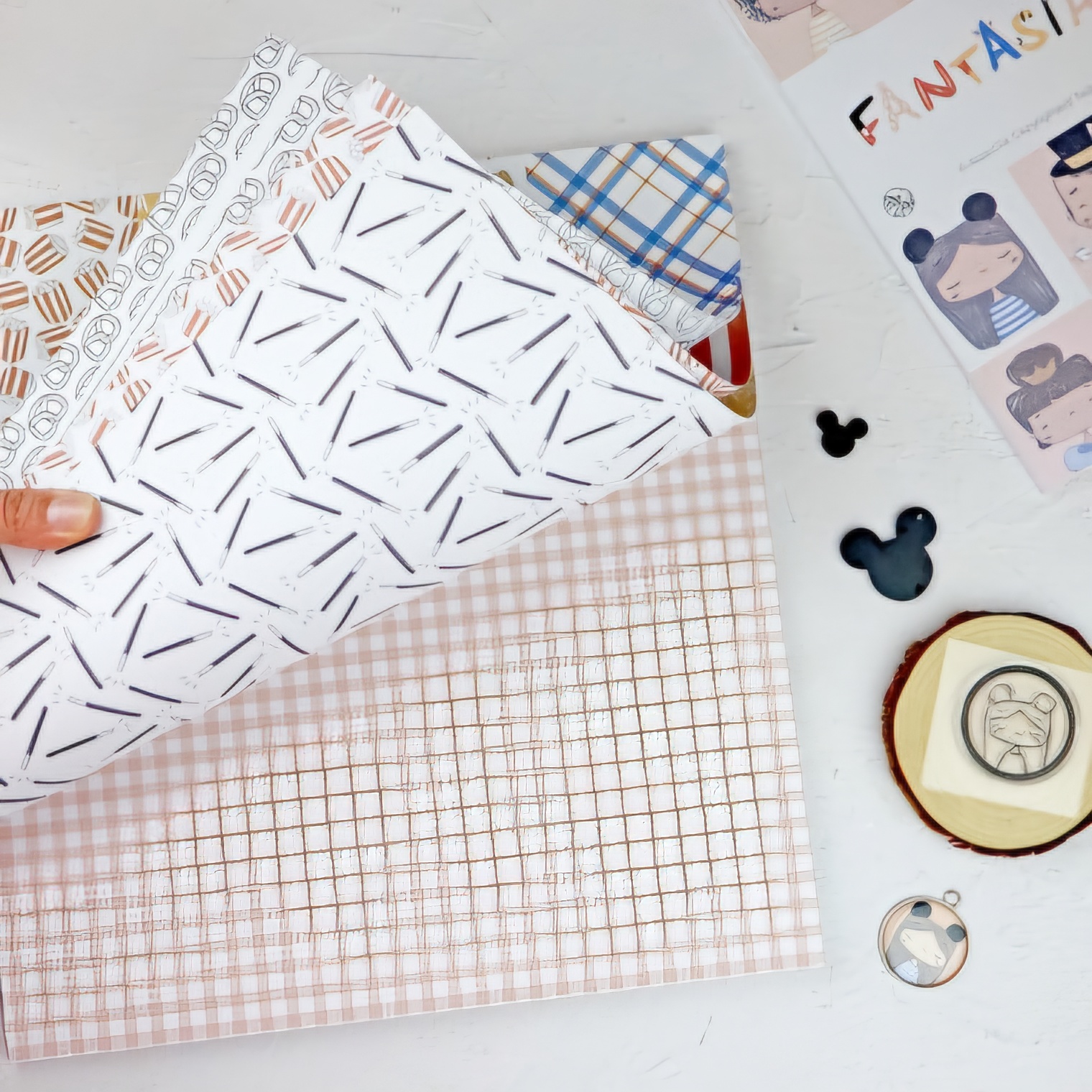 Folhas de papel decorativo com padrões variados e pendentes próximos