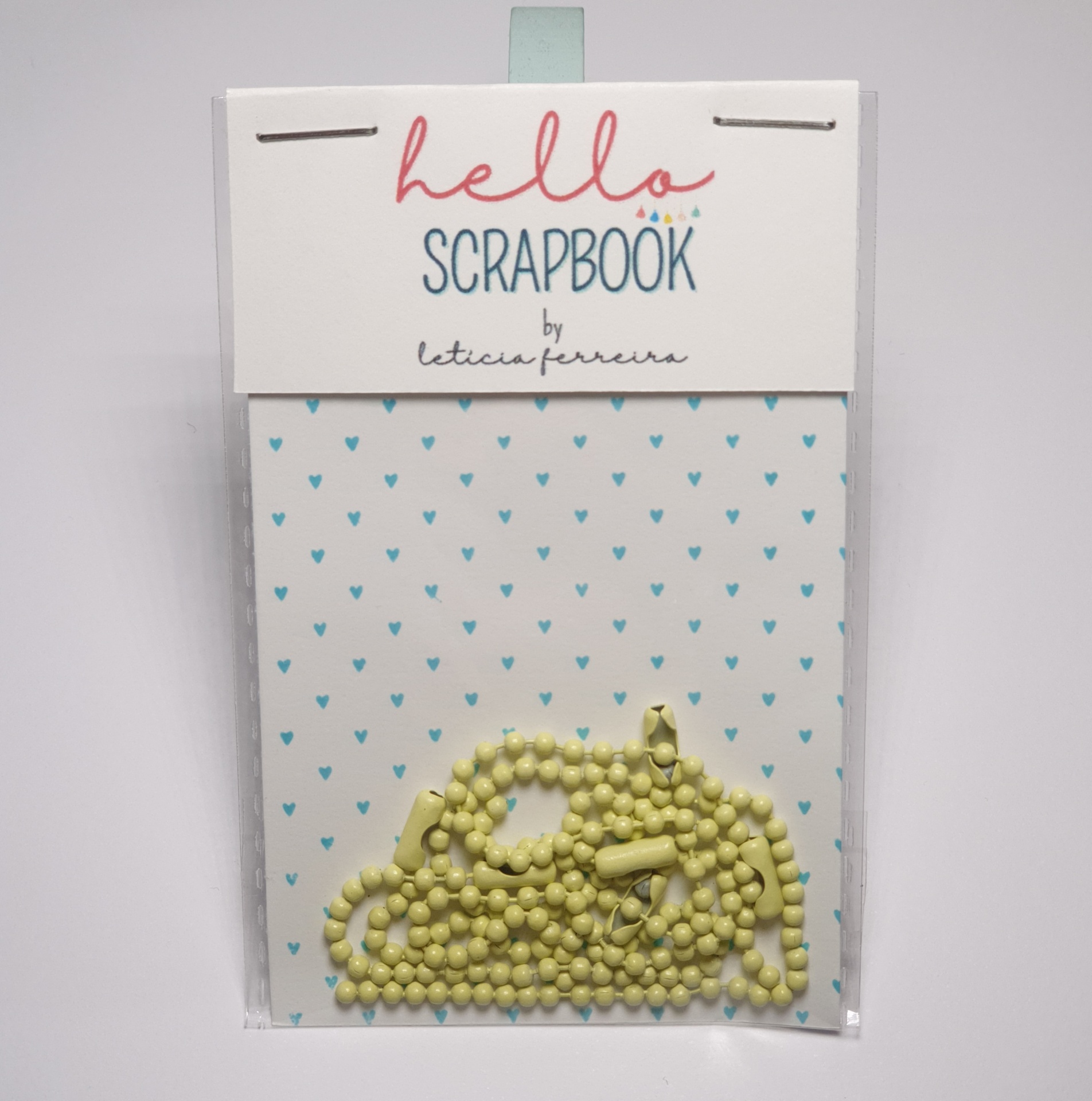 Pacote de scrapbook com padrão de corações azuis e uma peça decorativa amarela