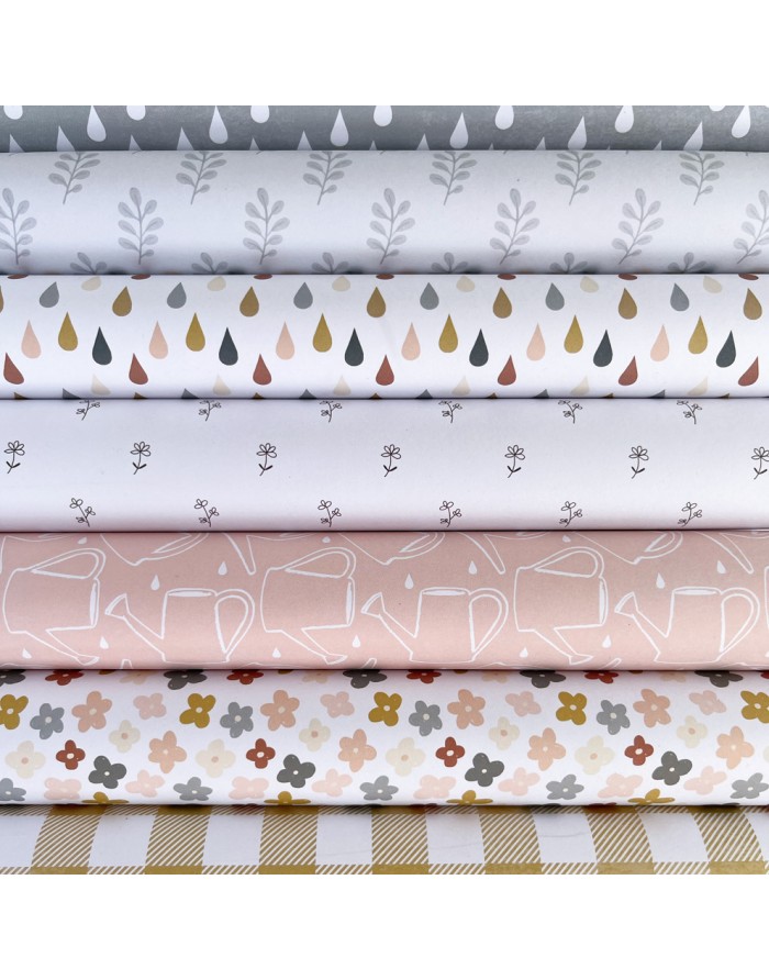 tecidos estampados com folhas, gotas, ramos, regadores, flores e padrão xadrez em cores suaves