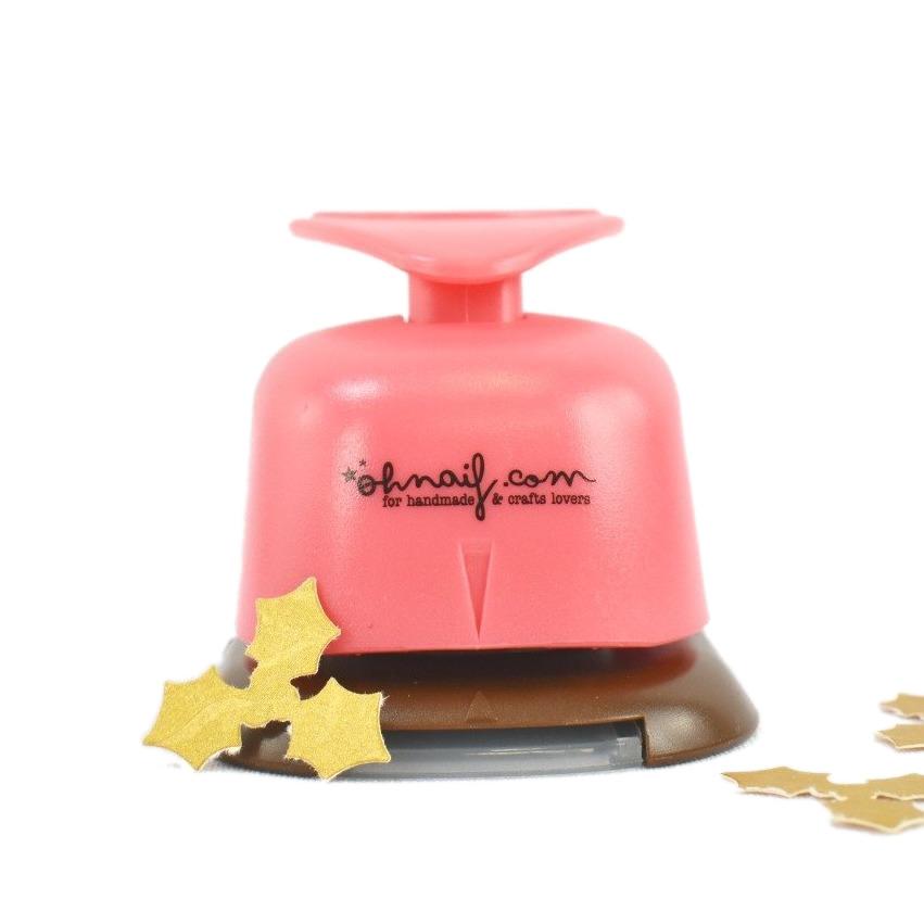 Ferramenta de corte para papel cor-de-rosa com base castanha e formas cortadas de papel amarelo