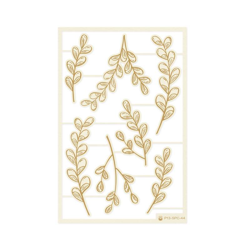 folhas decorativas bege e dourado numa folha branca