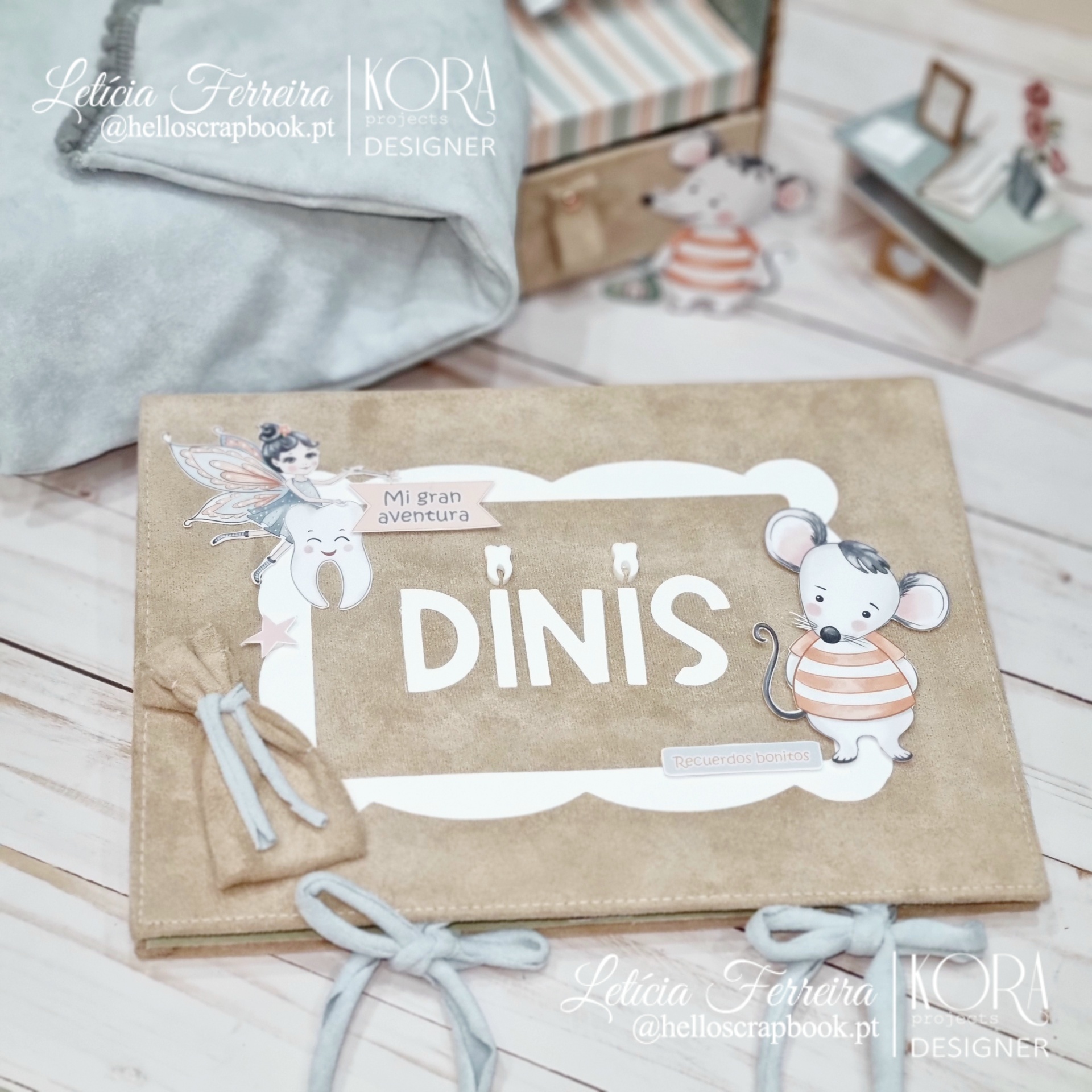 Livro ou álbum infantil com capa de tecido bege e ilustrações de rato e fada