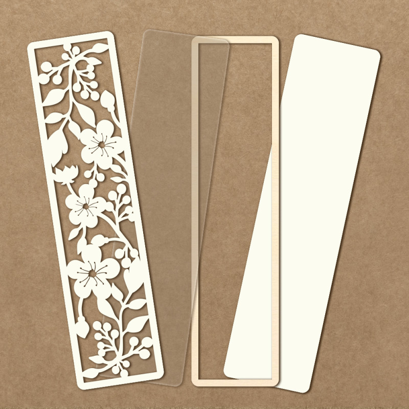 Quatro marcadores de página, um branco com padrão floral recortado e três lisos em tons de bege, sobre fundo castanho.