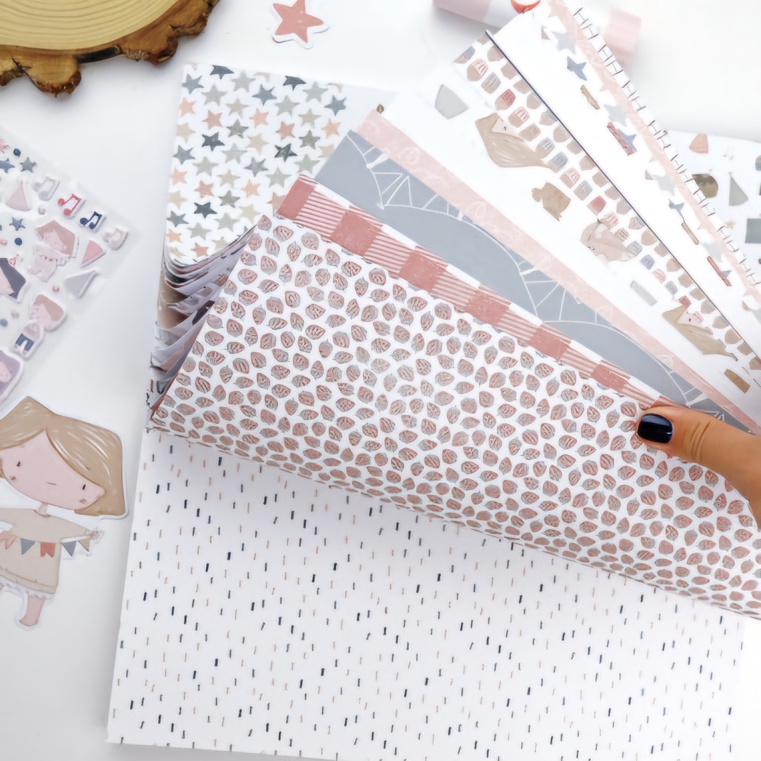 Folhas de papel decorativo com padrões variados em tons pastel