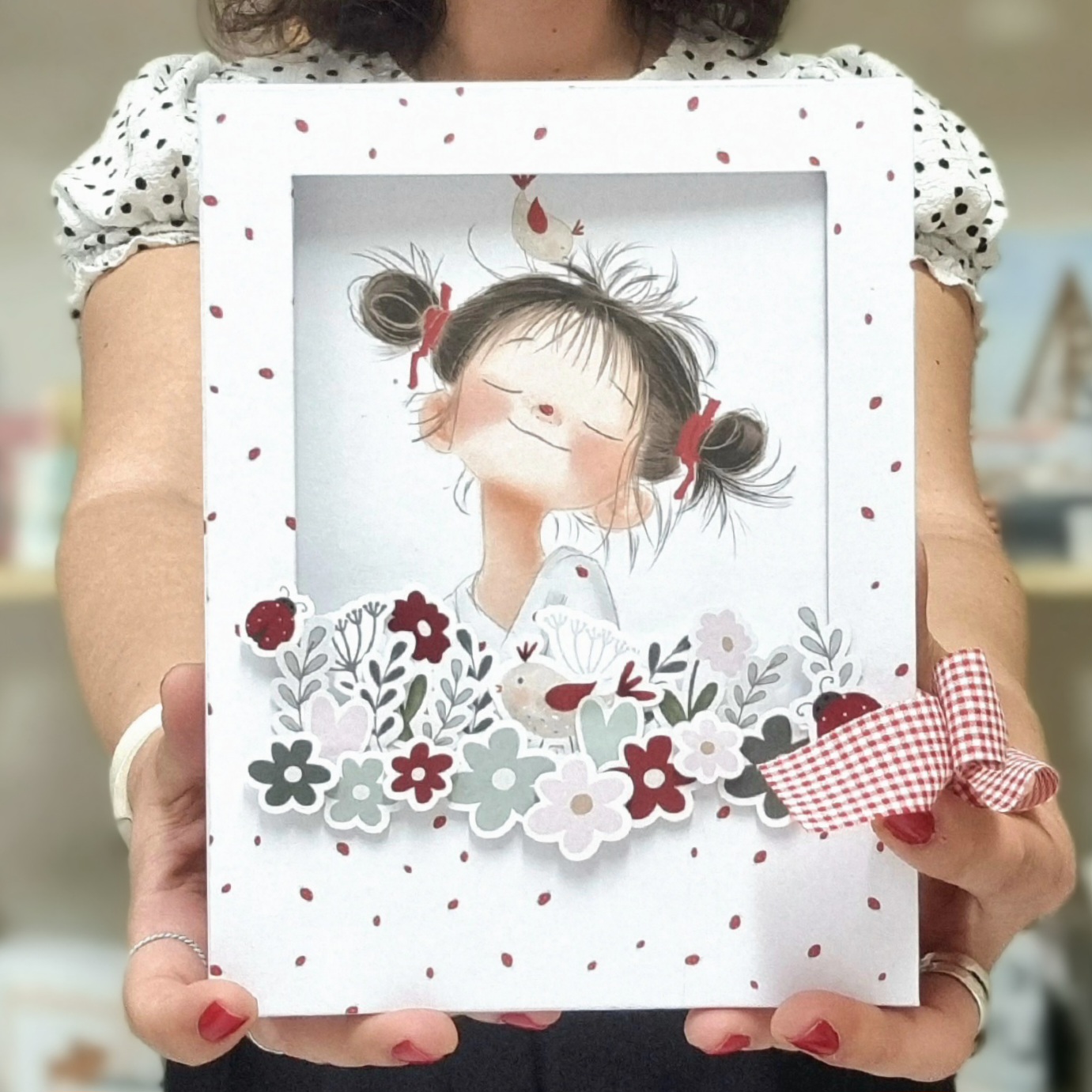 Caixa branca decorativa com ilustração de menina, pássaro e flores, com laço xadrez vermelho