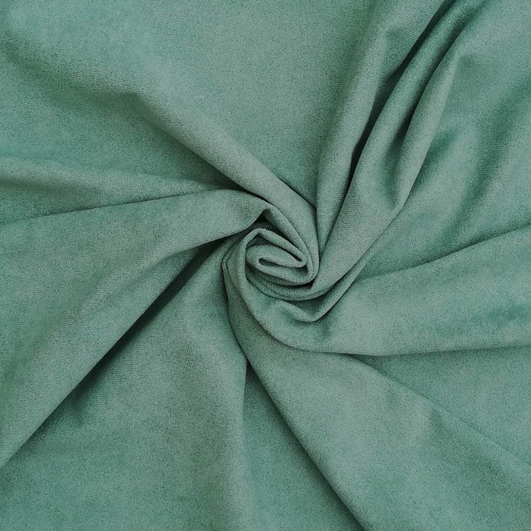 Tecido verde-água macio com textura suave enrolado no centro