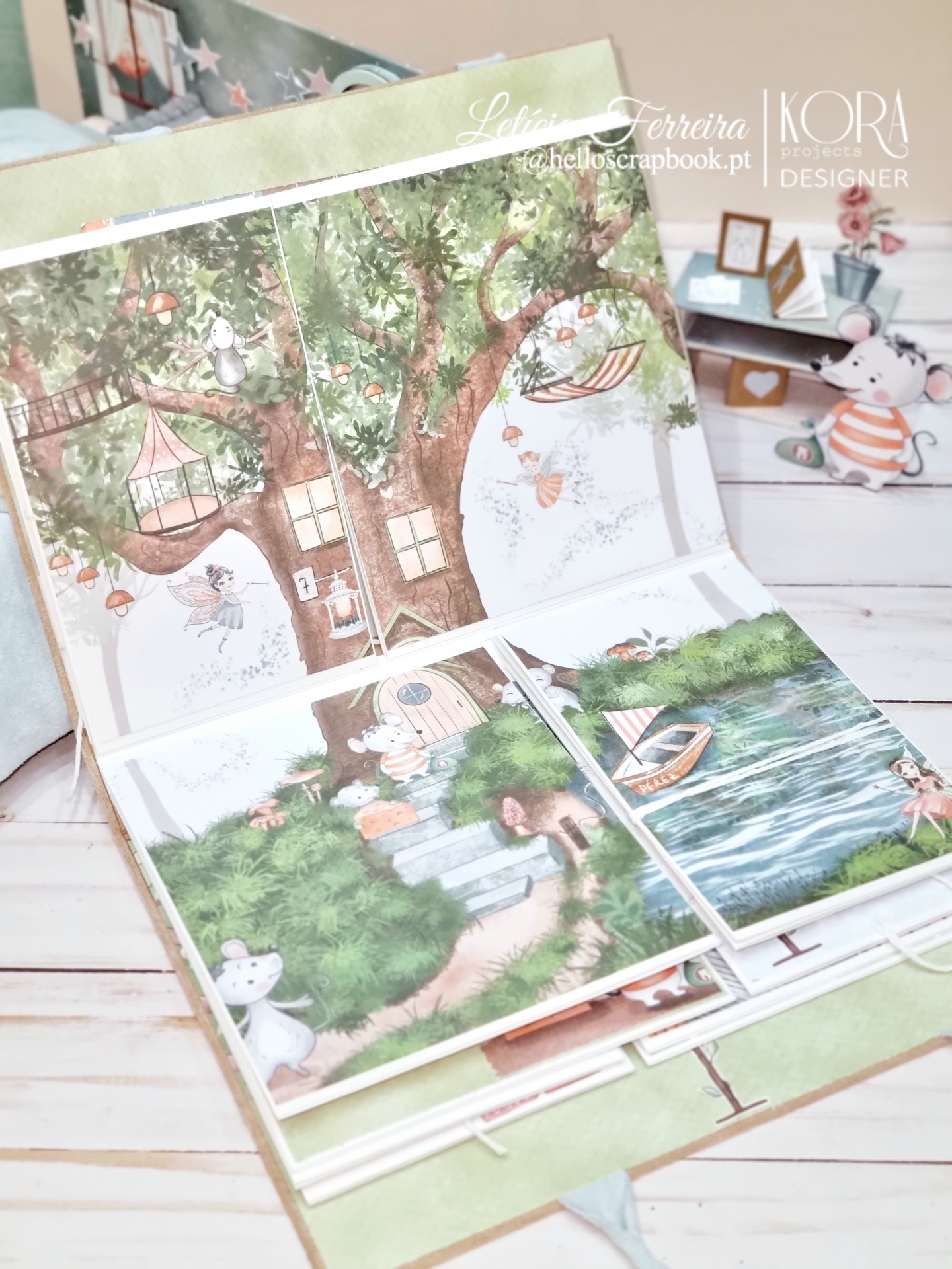 Livro interativo com ilustrações de árvore com casa na árvore, ratinhos, barco e lago