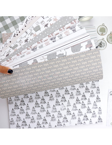 Folhas de papel decorativo com padrões variados em tons cinza e branco