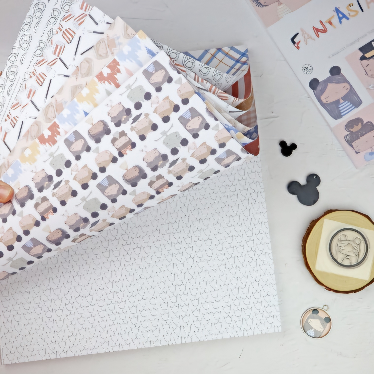 Folhas de papel decorativo com vários padrões e objetos decorativos ao redor