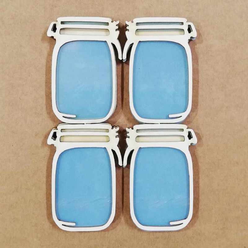 Quatro ímanes em forma de frascos azuis com moldura branca