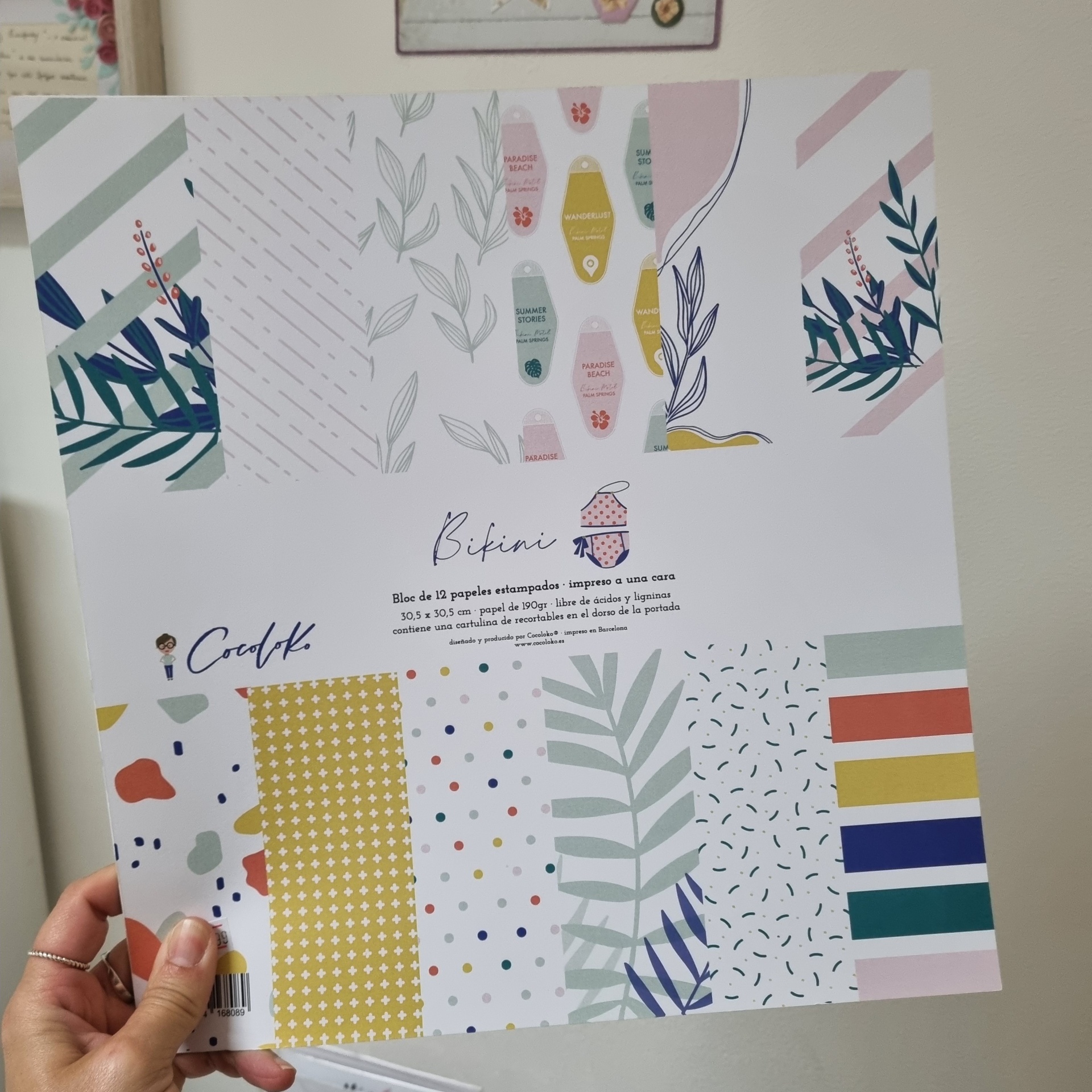 Folha de papel decorativo com padrões coloridos e texto em espanhol e inglês