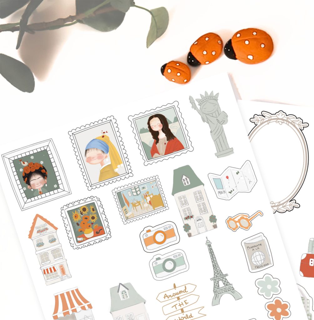 Folha de autocolantes variados e três joaninhas decorativas sobre superfície branca