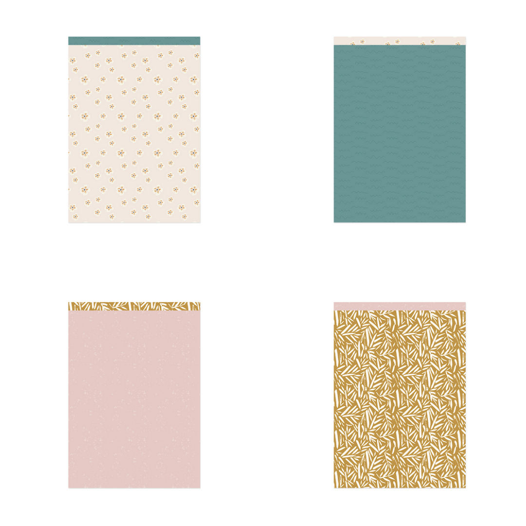 Quatro cadernos com capas decorativas de padrões florais e cores em bege, verde, rosa e castanho.