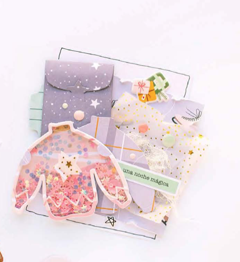 Cartões decorativos em formato de camisolas com padrões coloridos e texto 'una noche mágica'