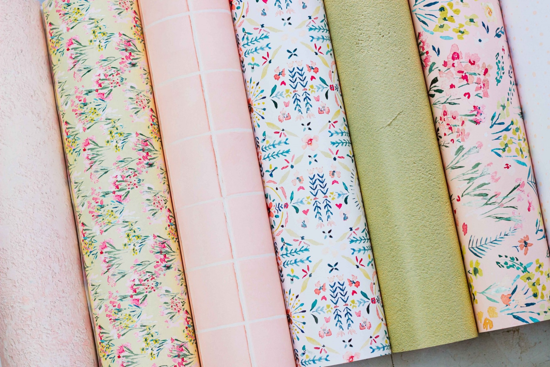 Seis rolos de papel com padrões florais de cores pastel