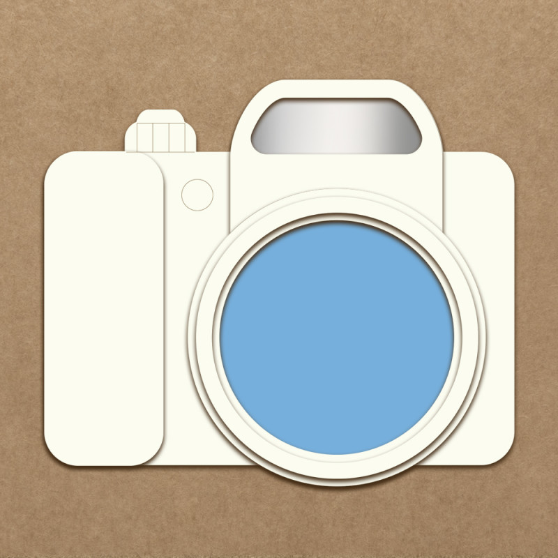 Ícone de máquina fotográfica digital creme com lente azul