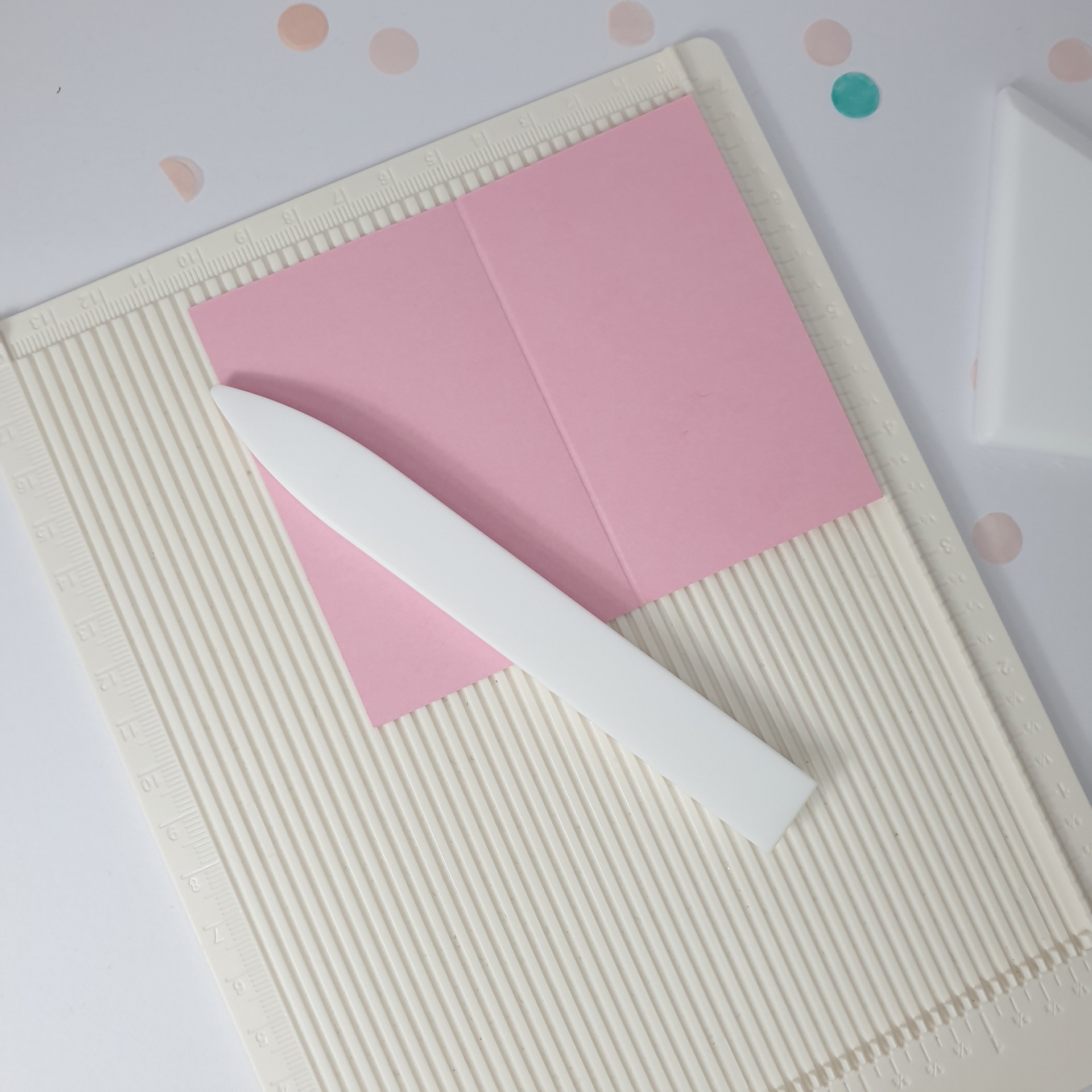 Tabuleiro branco de vinil estriado, papel rosa e osso branco para vincar