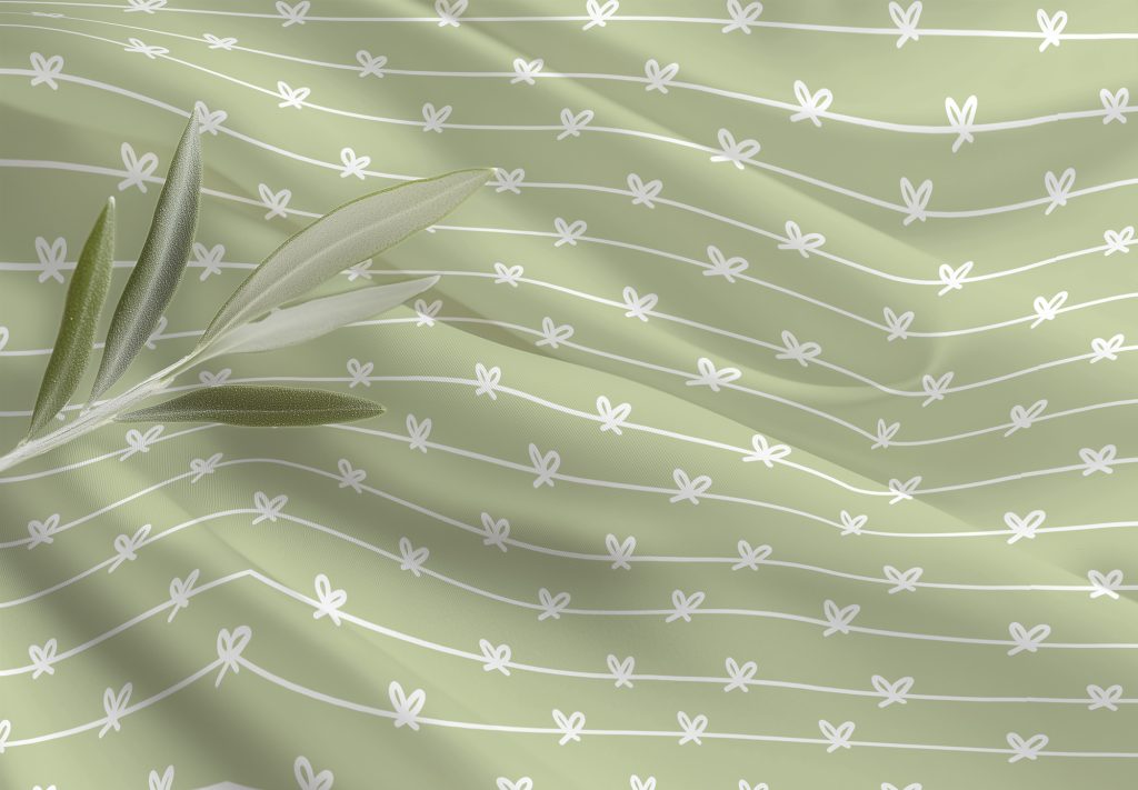 Tecido verde claro com padrão floral branco e folhas verdes