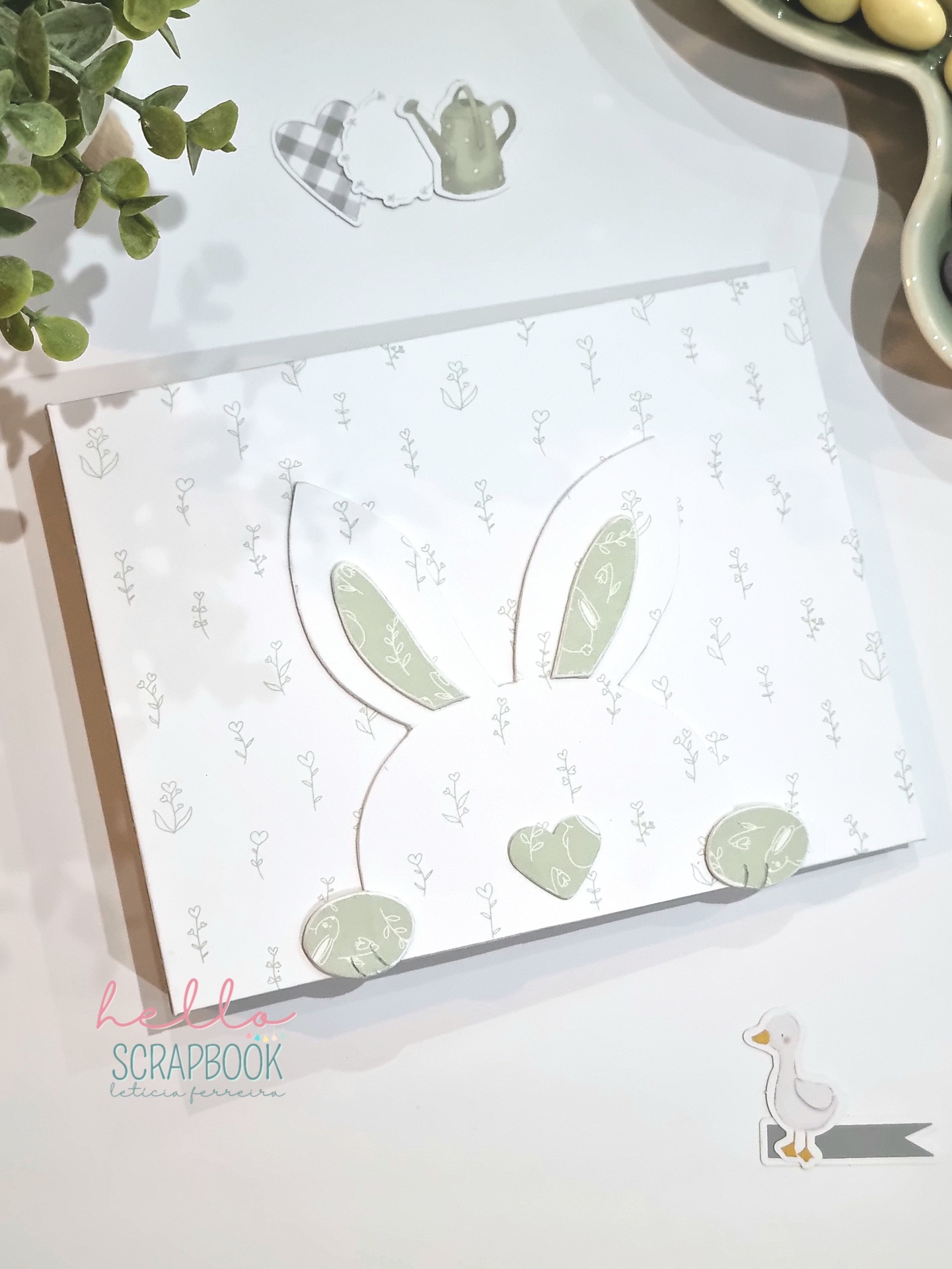 Álbum com capa decorada de coelho e desenhos flores e regadores