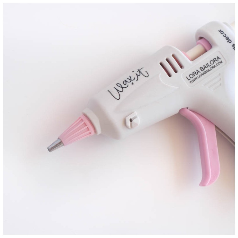 Pistola de cola quente branca e rosa com texto impresso