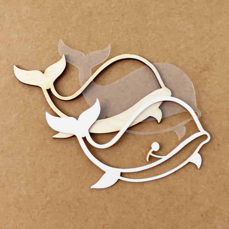 Moldes de baleia em madeira, plástico e branco sobre superfície castanha