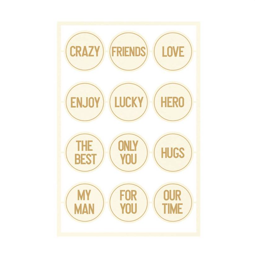 Folha branca com 12 autocolantes circulares cor creme claro com texto dourado