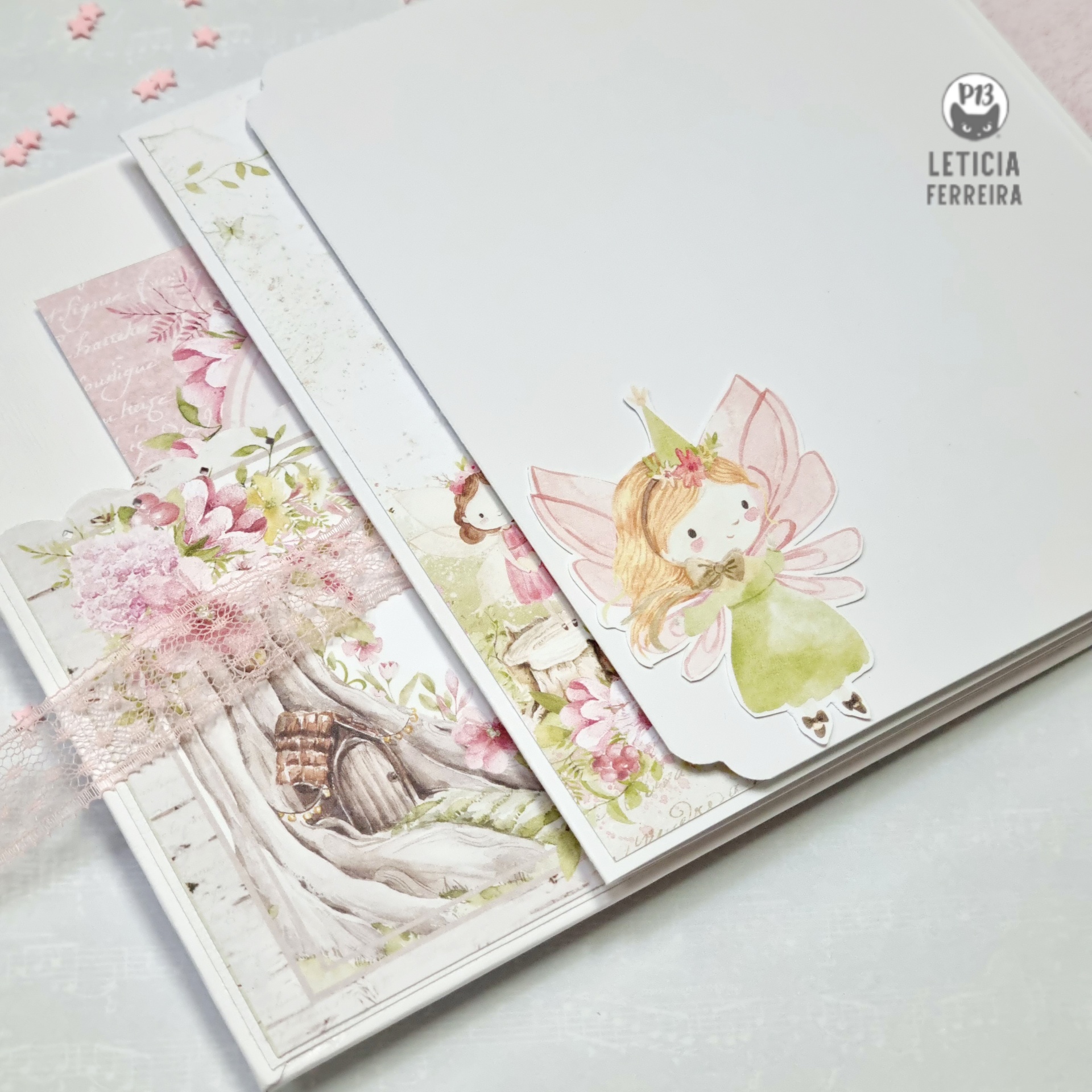 Três cadernos decorativos com capa de papel e ilustrações de fada e flores