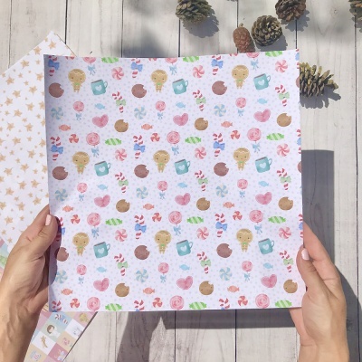 Folha de papel decorativa com padrão de biscoitos e doces nas mãos