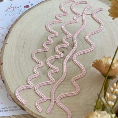 Cinco fitas decorativas rosas em padrão zig-zag sobre placa de madeira com flores secas e papel com texto