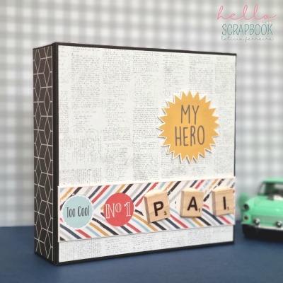 Caixa scrapbook decorativa com texto 'MY HERO', 'Too Cool', 'NO 1' e letras 'PAI' em peças de madeira