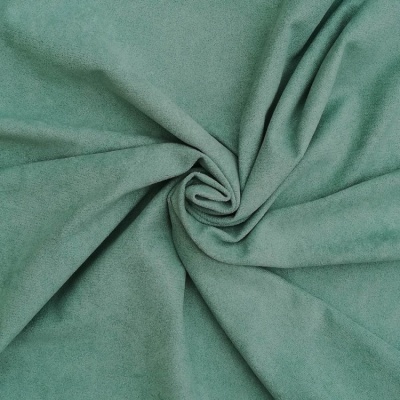 Tecido verde-água macio com textura suave enrolado no centro