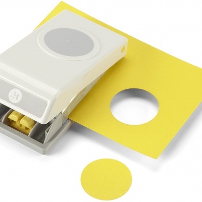 Furador de papel branco com papel amarelo perfurado