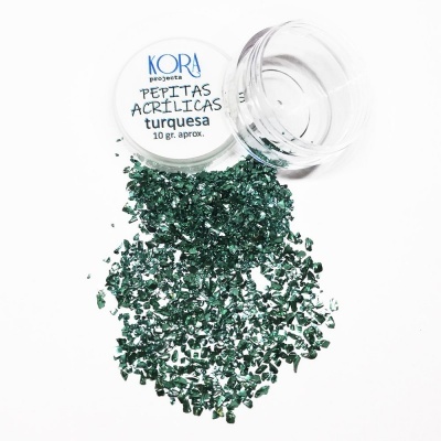 Frasco com pepitas acrílicas turquesa da KORA PROGETS e pepitas espalhadas